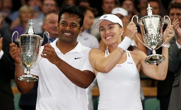 Leander Paes of India, left, and Martina Hingis of Switzerland hold up the trophies after winning the mixed doubles final against Alexander Peya of Austria and Timea Babos of Hungary at the All England Lawn Tennis Championships in Wimbledon (Photo: Leander Paes of India, left, and Martina Hingis of Switzerland hold up the trophies after winning the mixed doubles final against Alexander Peya of Austria and Timea Babos of Hungary at the All England Lawn Tennis Championships in Wimbledon (Photo:
